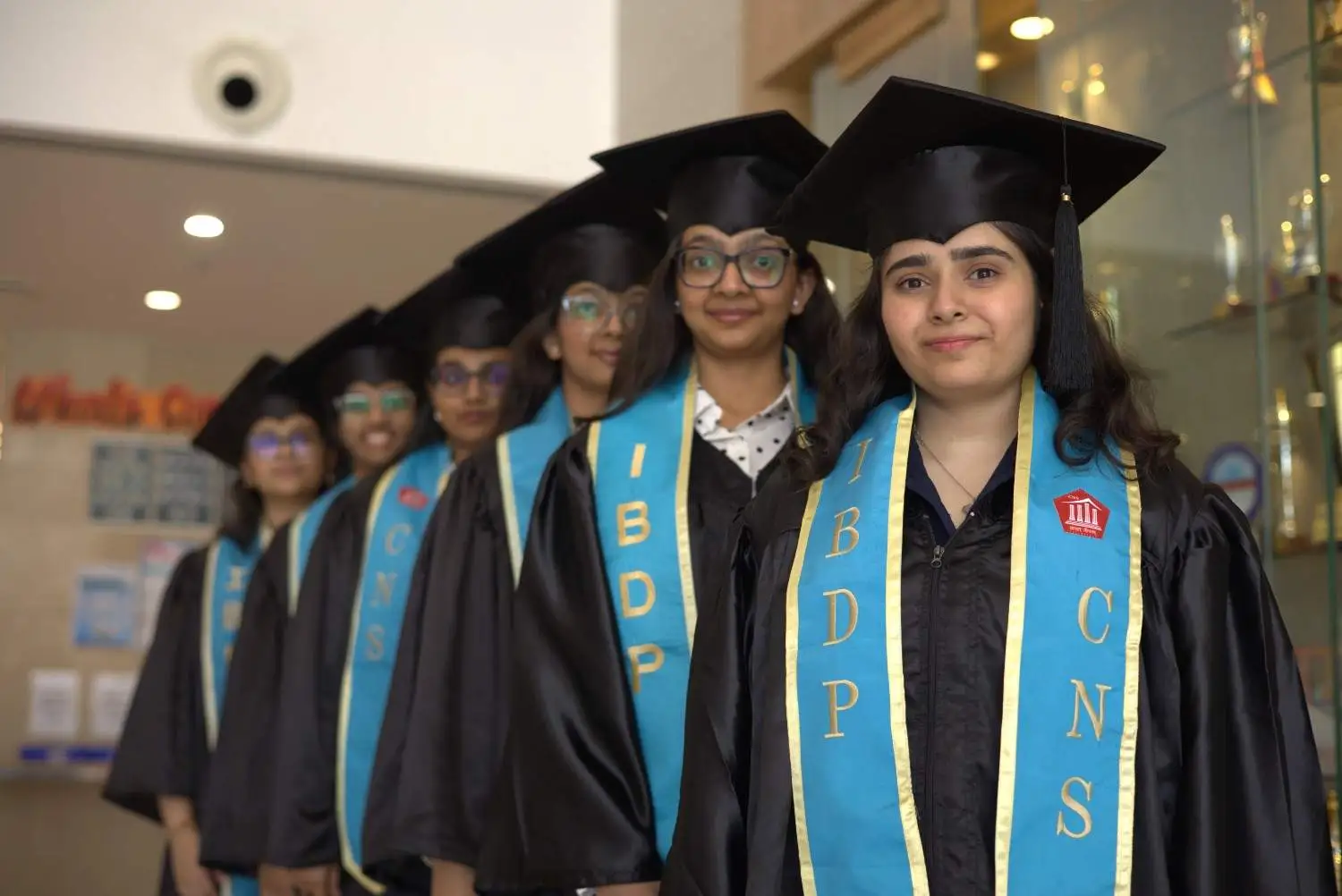 Students in graduation gowns representing informed A Level subject choices and future academic pathways